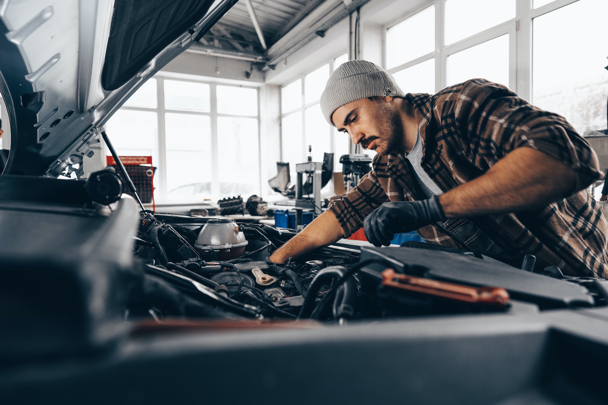 Mechanic examining car in auto car repair service center